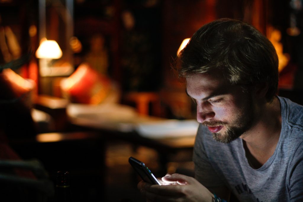 man using phone at night