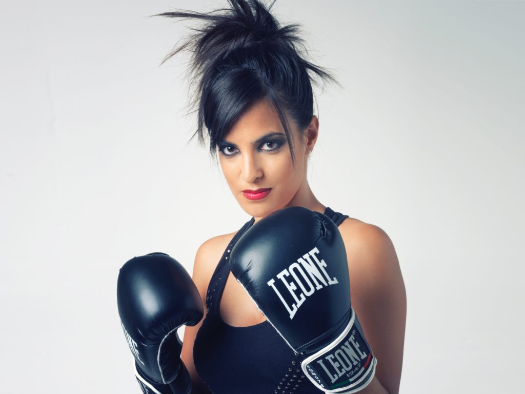 boxer woman wearing black Leone leather boxing gloves