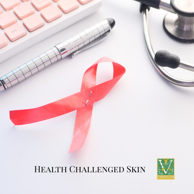 health challenged skin, with pink cancer awareness ribbon, pen, keyboard, and part of stethoscope